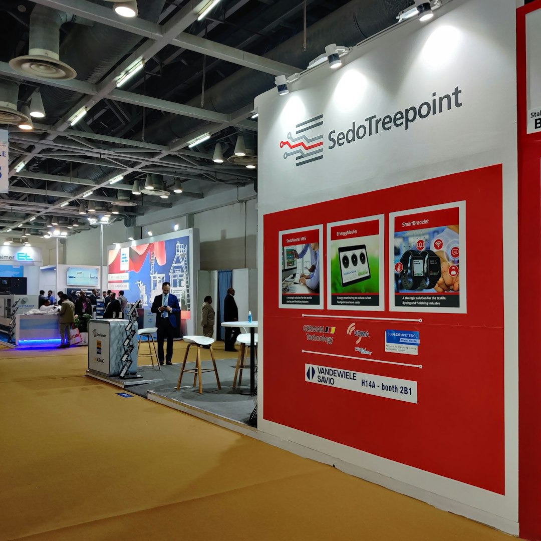 People milling around busy trade show booths displaying products.